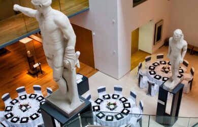 A high angle photo looking down on the tables that have been laid for an event