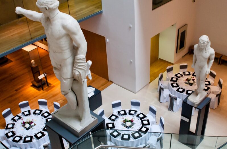 A high angle photo looking down on the tables that have been laid for an event