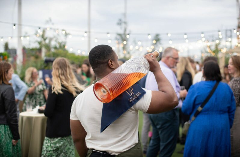 man holding magnum bottle of wine