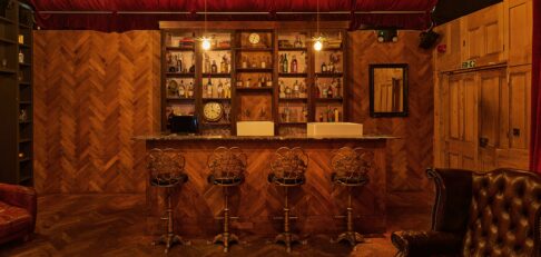 The Drawing Room at the BFI Southbank - A wooden clad bar with high streets in an apothecary style room